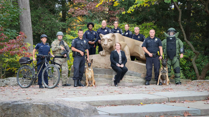 Officers standing at Lion Shrine. 